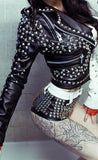 Woman wearing a split black and white punk leather jacket with heavy silver spikes and studs.