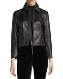 Women's black cropped studded lambskin leather jacket with silver studs outlining the seams and collar.