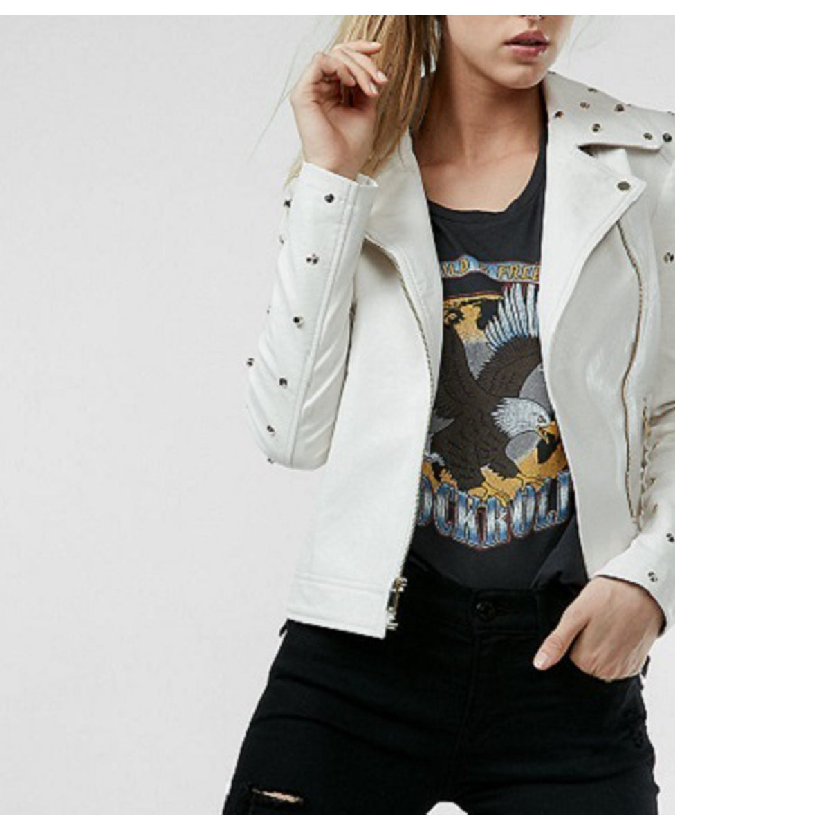 Woman wearing a white leather biker jacket with golden studs and an asymmetrical zipper.