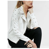 Woman wearing a white leather biker jacket with golden studs and an asymmetrical zipper.