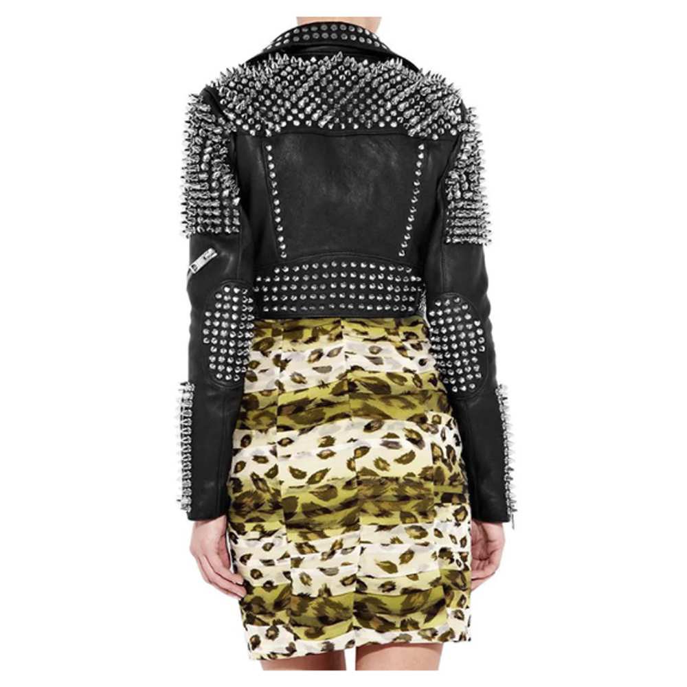 Women's studded black leather punk jacket with heavy silver spikes on the shoulders and studs on the lapels.