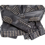 Women's black slim-fit Brando leather jacket featuring silver conical spikes on shoulders and back, dome studs, and a belted waist.