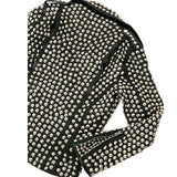 Women's black leather biker jacket fully covered in silver dome studs, rock star style with asymmetrical zipper.